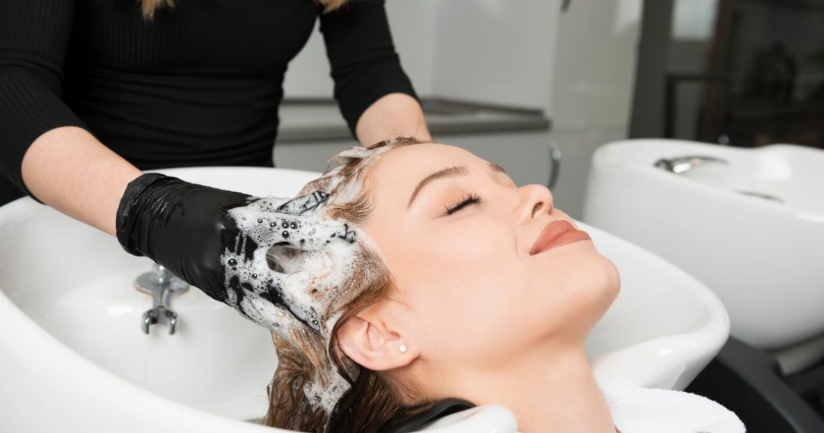 Woman having hair washed in salon