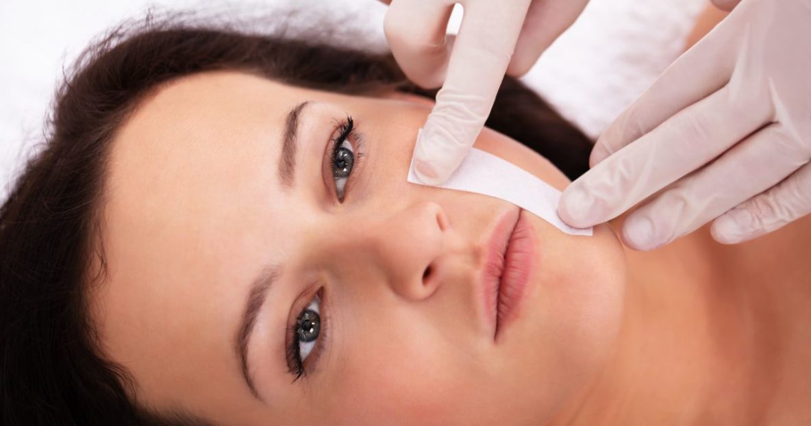 woman having face waxed