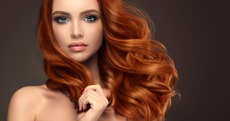Beautiful model with long red curly hair