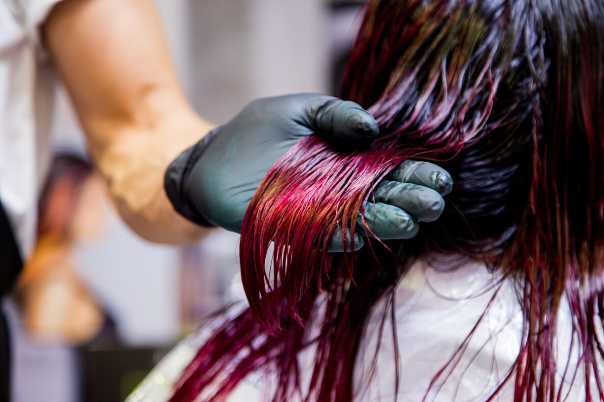 Professional hairdresser dyeing hair.